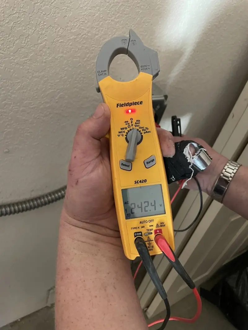 Voltage testing with clamp meter during Outlet Installation in Watertown